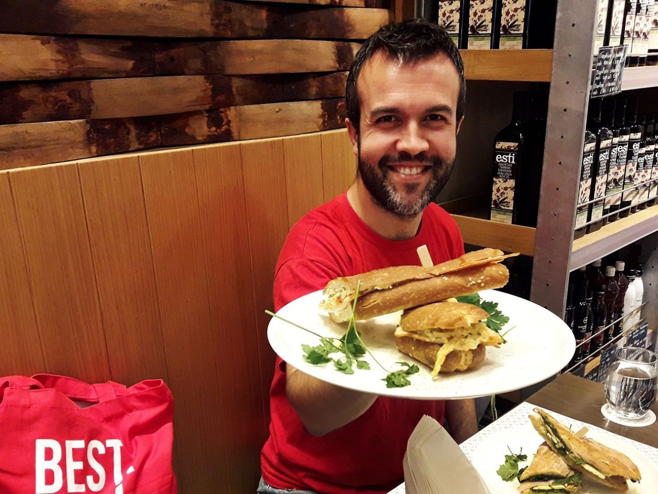 a man sitting at a table with a plate of food