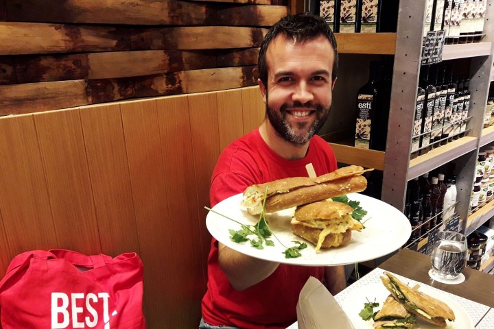 a man sitting at a table with a plate of food