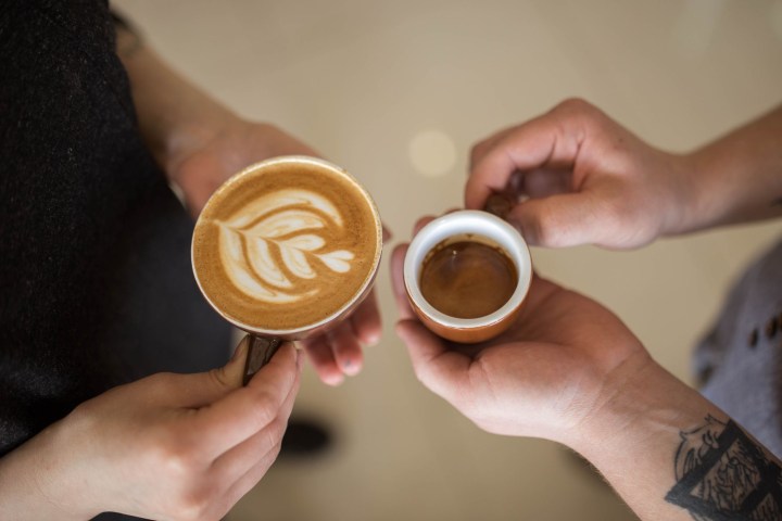 a hand holding a coffee mug