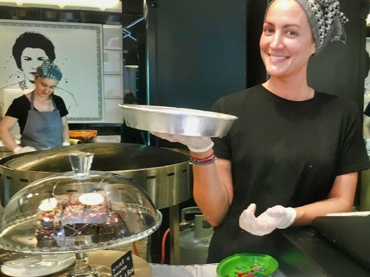 a man and a woman standing in front of a table