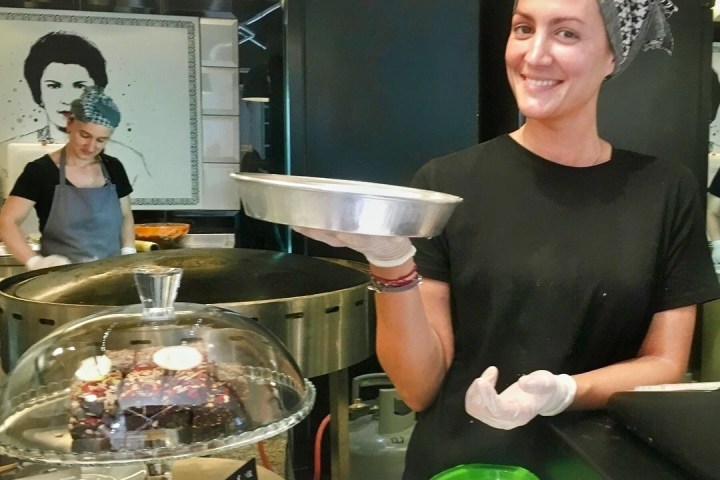 a man and a woman standing in front of a table