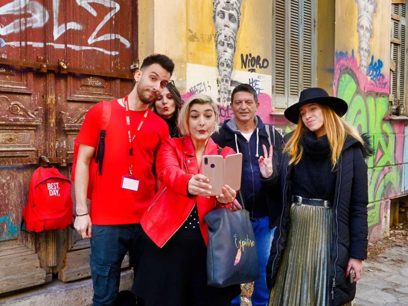 a person standing in front of a group of people posing for the camera