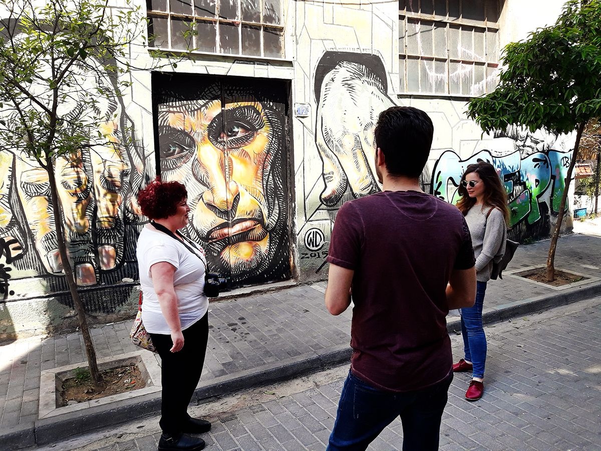 a group of people standing on a sidewalk
