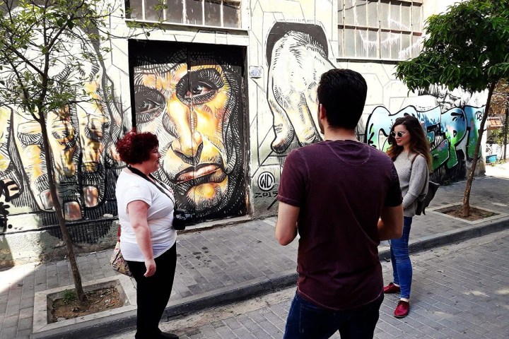 a group of people standing on a sidewalk