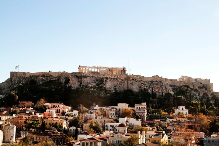 a large building with a mountain in the background