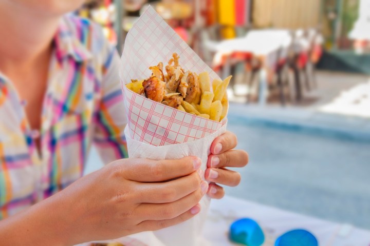 a woman holding a piece of food
