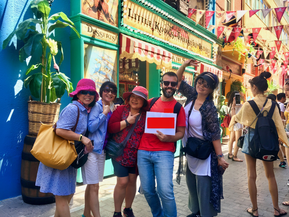 Kay Iwata et al. standing in front of a building