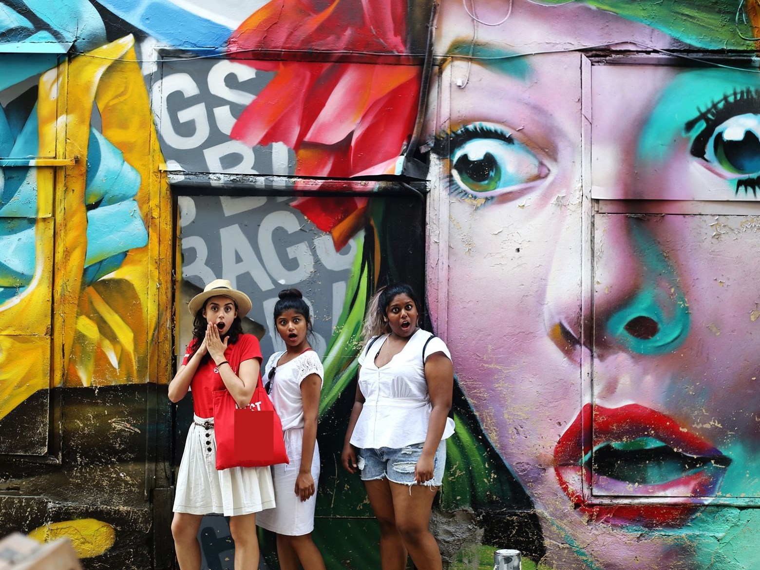 a person standing next to a body of water posing for the camera