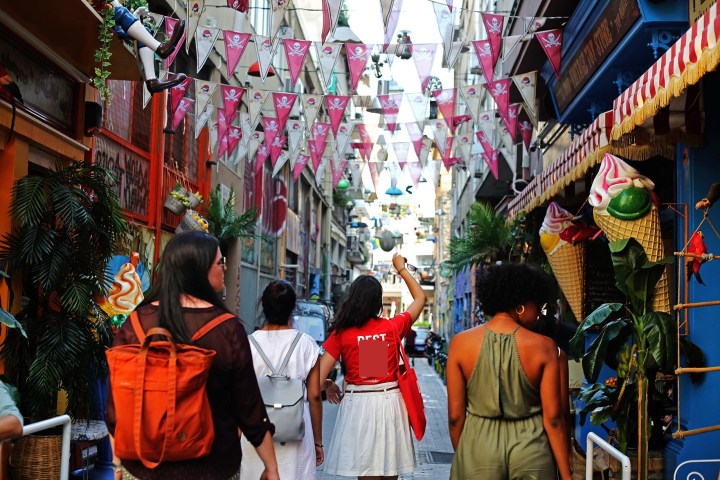 a group of people walking in front of a store