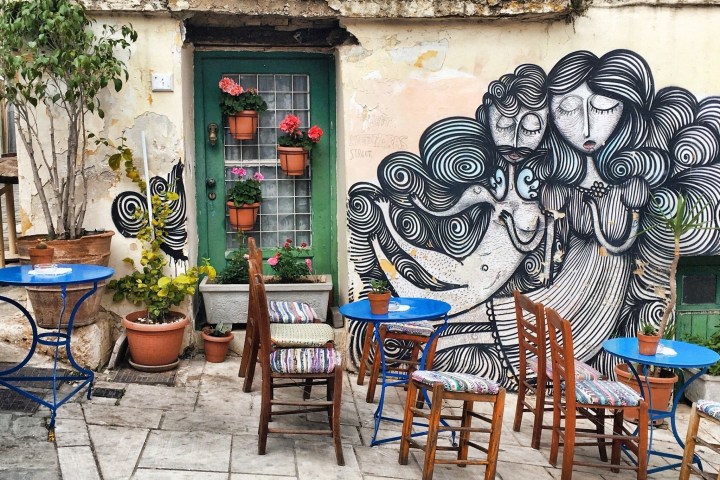 a group of people sitting at a table covered with graffiti