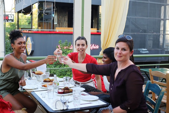 a group of people sitting at a table eating food