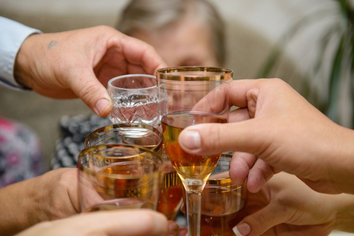 a hand holding a glass of wine